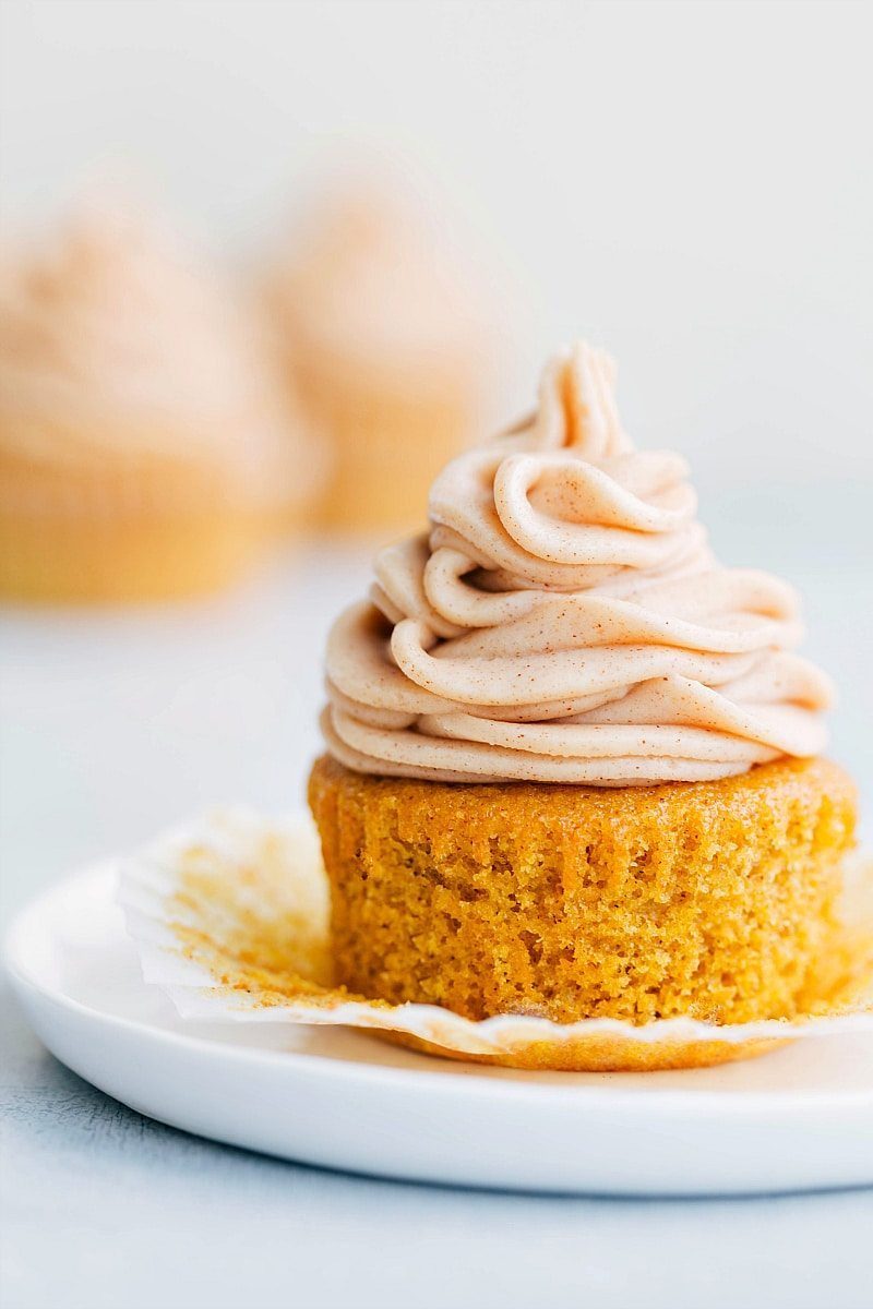 Finished moist pumpkin cupcake with a generous amount of frosting, satisfying and ready to be enjoyed for this pumpkin spice desserts roundup.