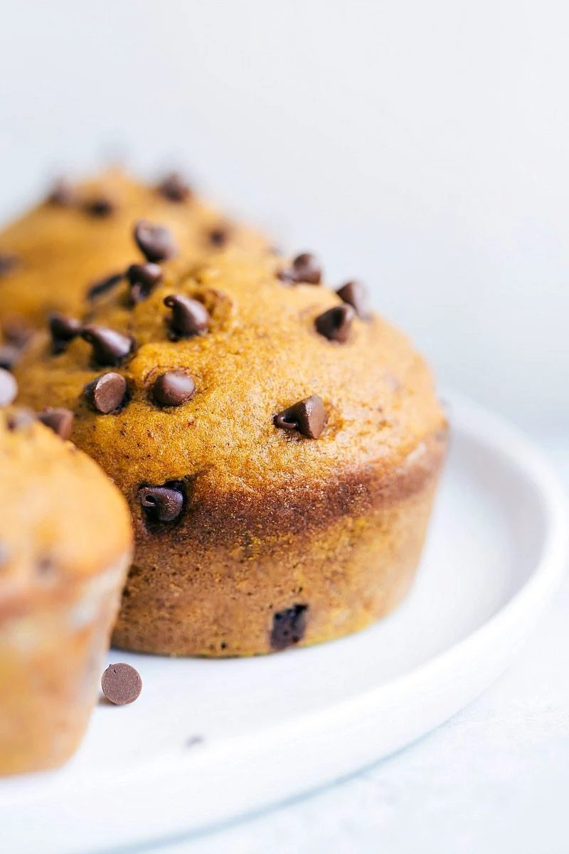 Pumpkin spice desserts with pumpkin muffins baked with mini chocolate chips inside and sprinkled on top.