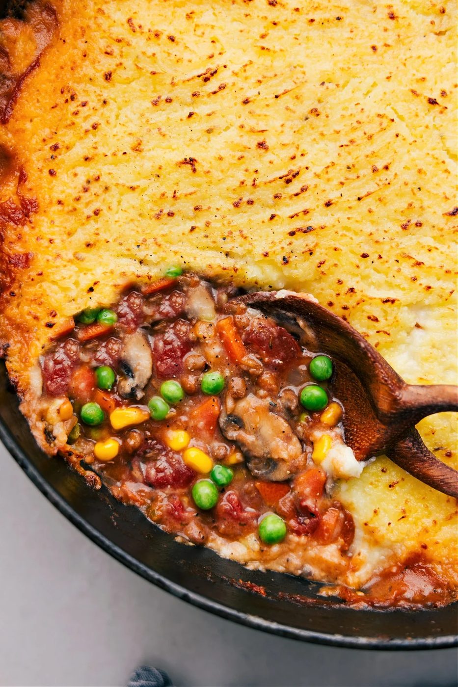 Vegetarian recipes: vegetarian shepherd’s pie in a skillet with a big scoop being served.