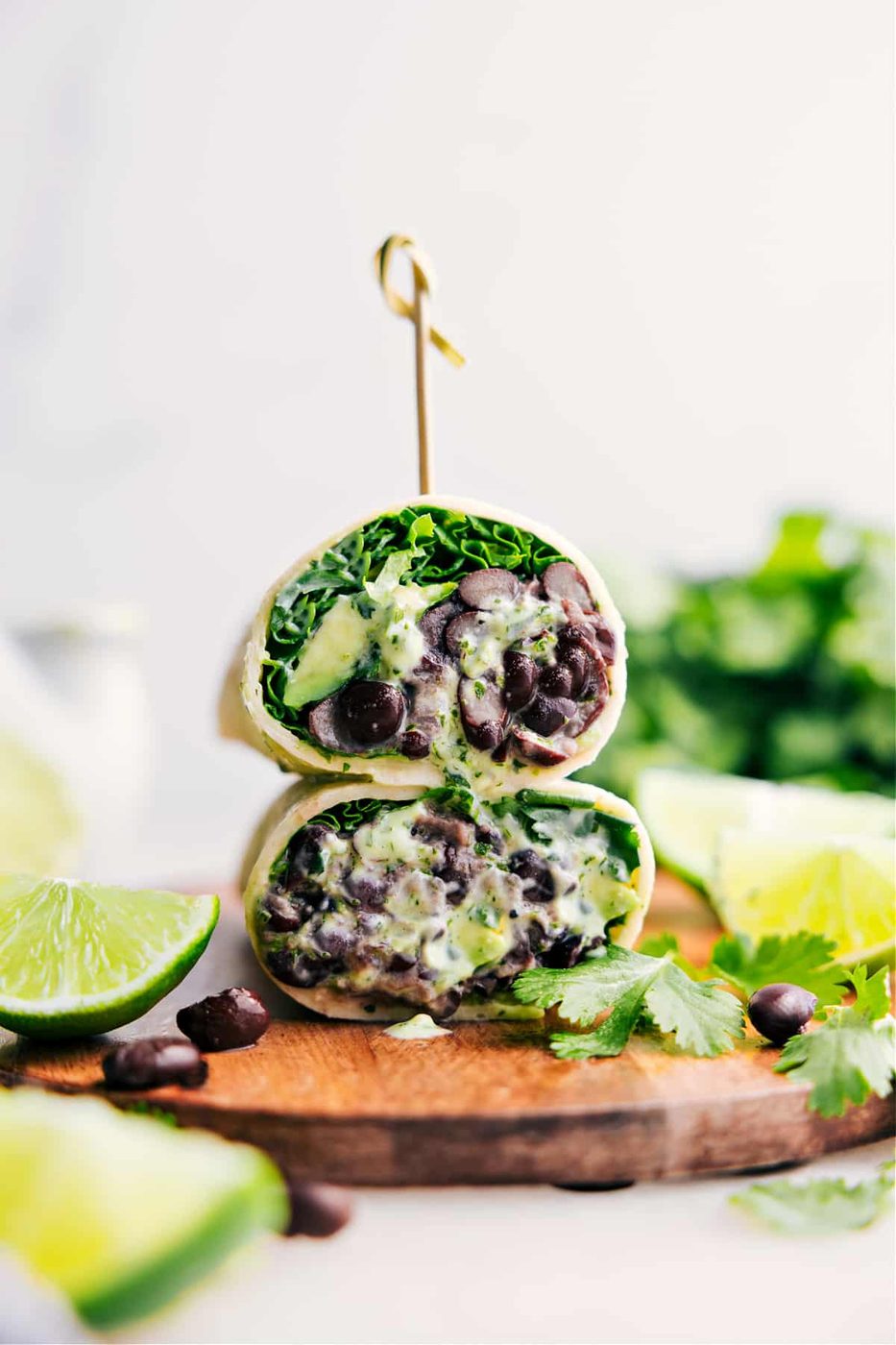 Black Bean Wraps cut in half and stacked with a creamy sauce.
