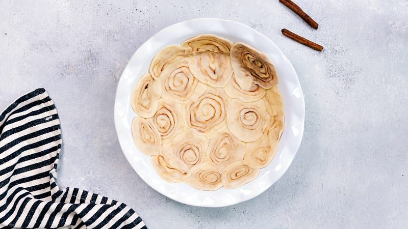 Cinnamon roll pie crust made by arranging cinnamon-filled pie dough spirals in the pan.
