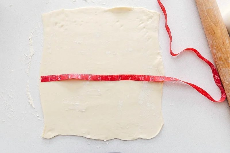 The dough rolled out and prepped to fill with the filling.