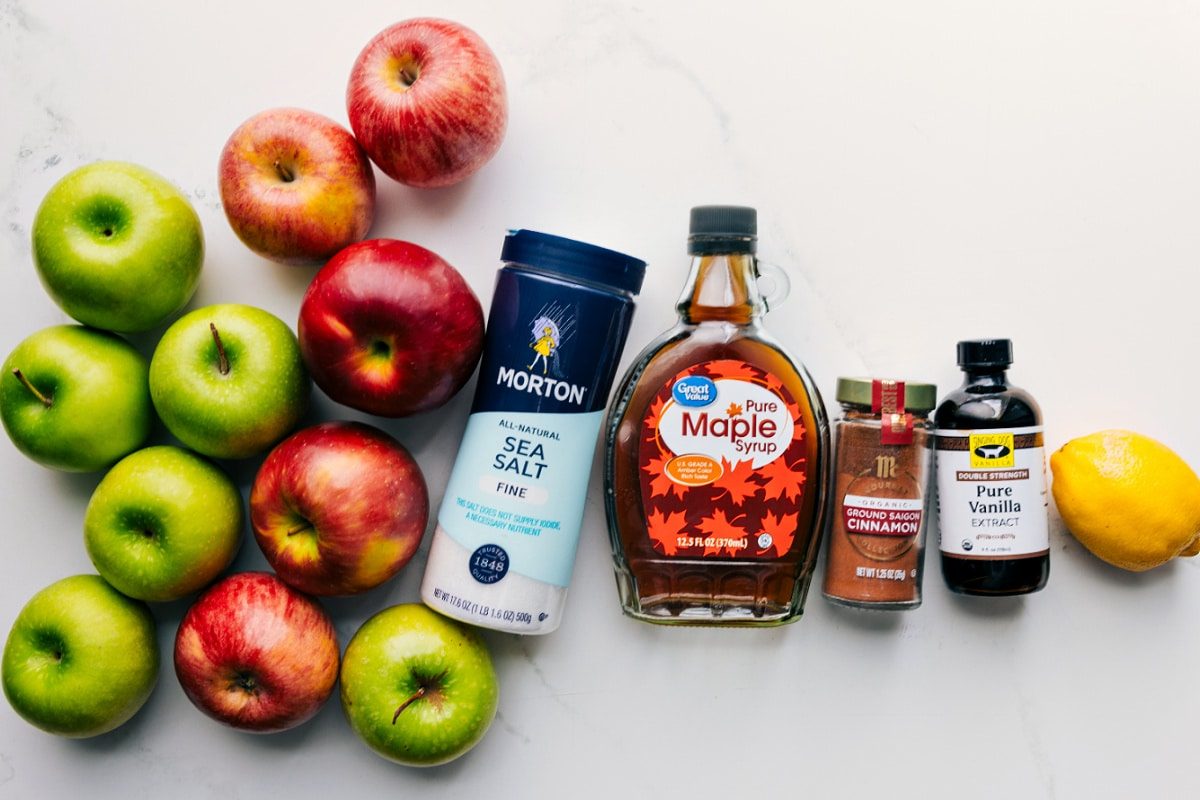 All the ingredients in this recipe prepped out for straightforward assembly including the apples, salt, maple syrup, cinnamon, vanilla, and lemon.
