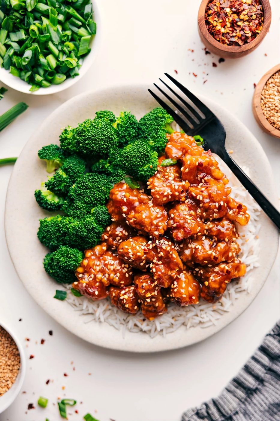 Panda express orange chicken over rice with broccoli on the side.