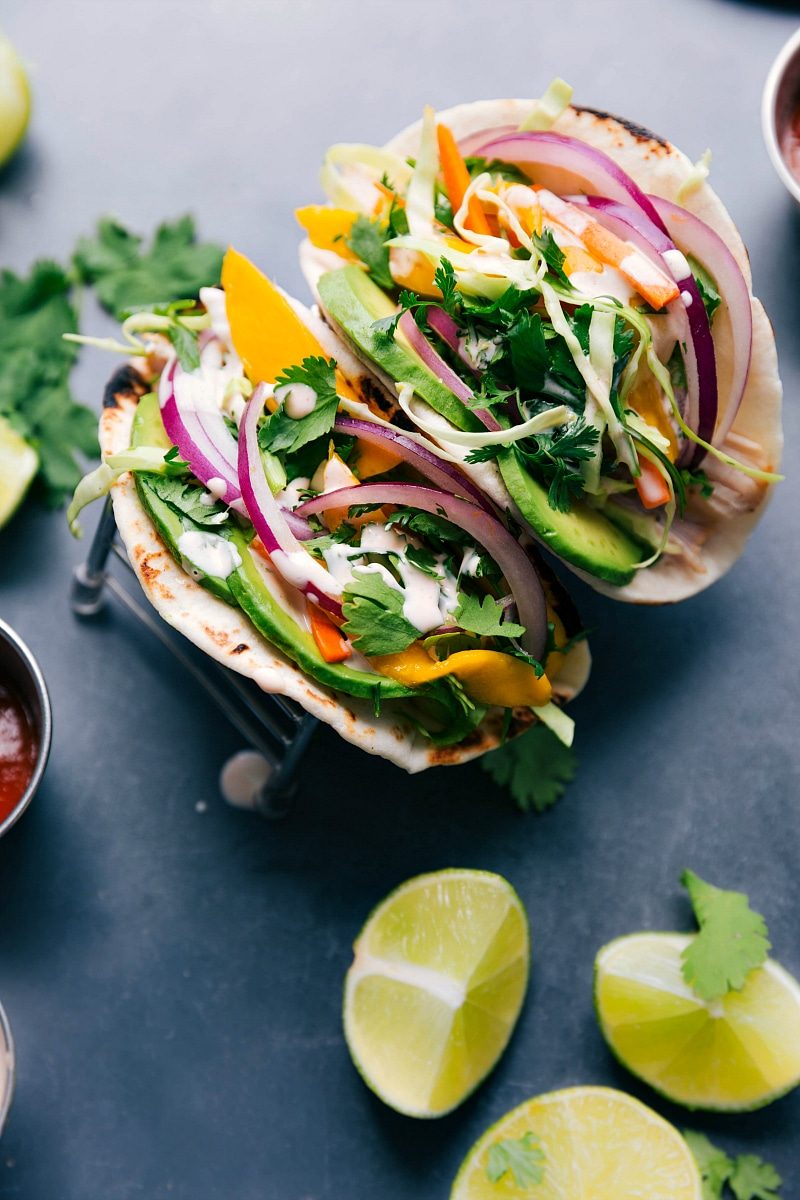 Two asian chicken tacos with chicken, slaw, and sauce, satisfying and flavor-packed.