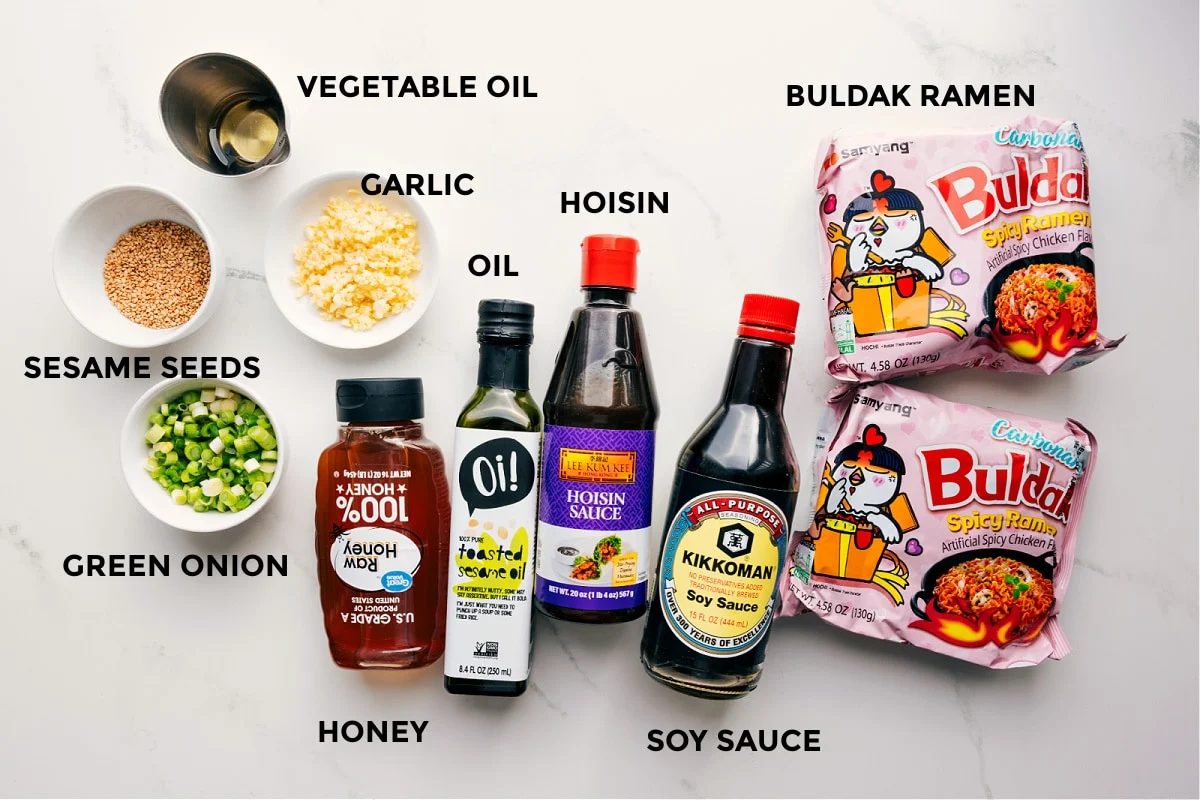 All the ingredients in this recipe prepped out for straightforward assembly including the sesame seeds, green onion, vegetable oil, garlic, honey, sesame oil, hoisin, soy sauce, and Buldak ramen.