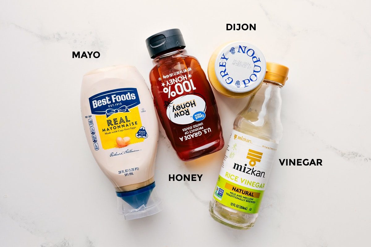 The dressing ingredients for Asian Slaw Recipe prepped out for straightforward assembly including the mayo, honey, dijon, and vinegar.