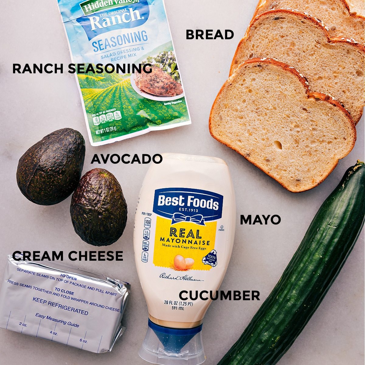 All the ingredients in this recipe are prepped for straightforward assembly, including bread, ranch seasoning, veggies, mayo, and cream cheese.