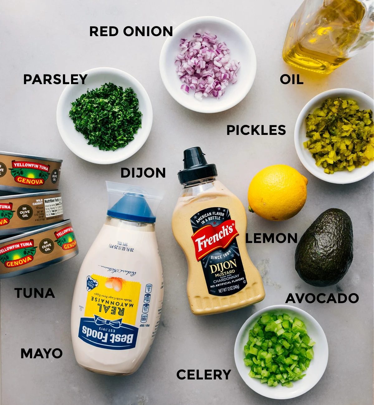 All the ingredients—meat, parsley, red onion, pickles, oil, lemon, avocado, Dijon, mayo, and celery—are prepped for straightforward assembly.