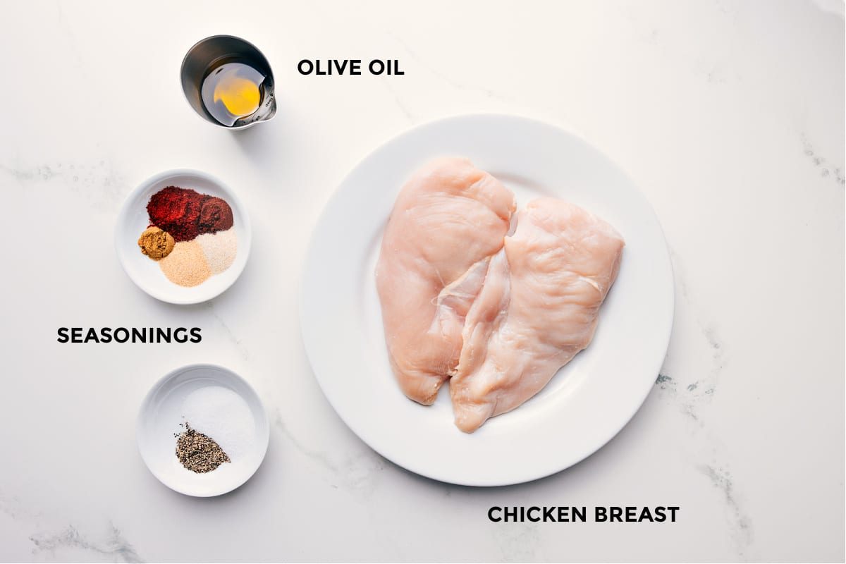 Ingredients in this recipe prepped out for straightforward assembly including the olive oil, seasonings, and chicken.