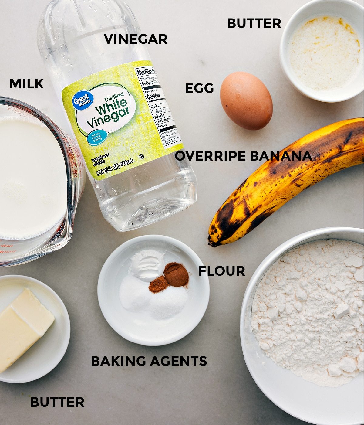 All ingredients for the banana pancake recipe prepped and laid out for straightforward assembly, including bananas, flour, eggs, and syrup.