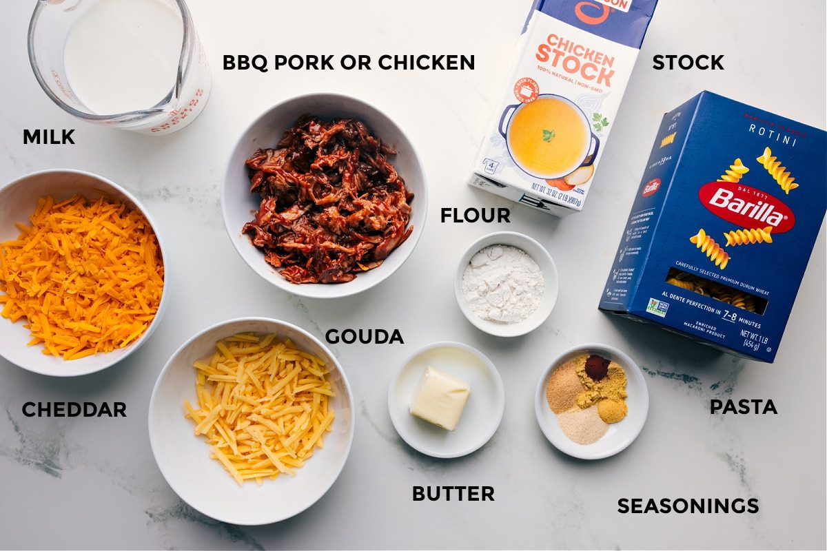 Ingredients prepped and ready for straightforward assembly: pork or chicken, milk, cheddar, gouda, flour, butter, seasonings, pasta, and stock.