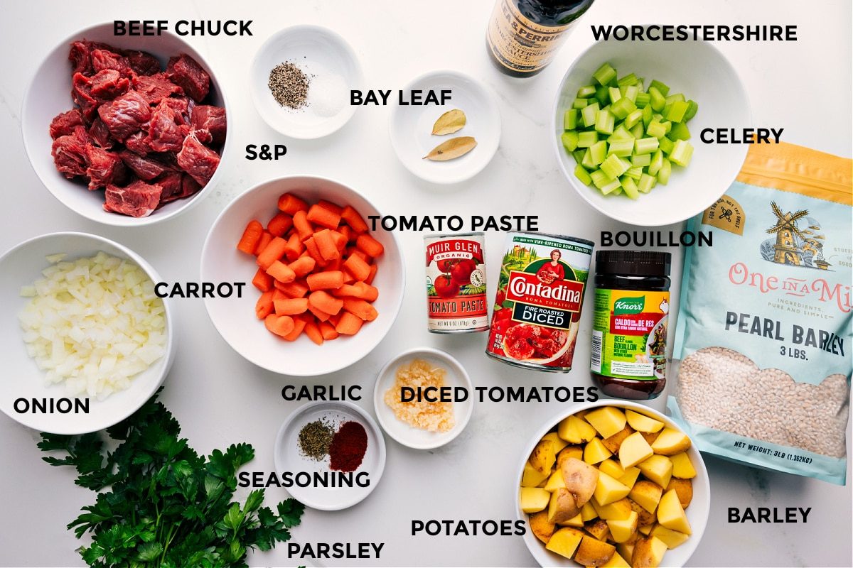 All the ingredients in this recipe prepped out for straightforward assembly including onion, carrot, beef, seasonings, tomato paste, potatoes, barley, celery, and Worcestershire.