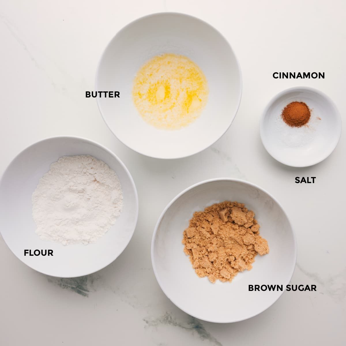 The crumb topping prepped into bowls for straightforward assembly including flour, butter, brown sugar, and cinnamon.