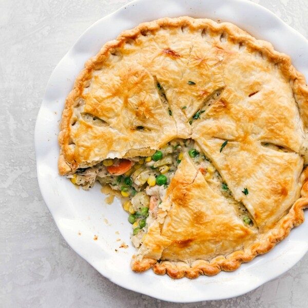 from-scratch chicken pot pie recipe with a slice removed, showcasing a beautifully golden crust, ready to be savored.