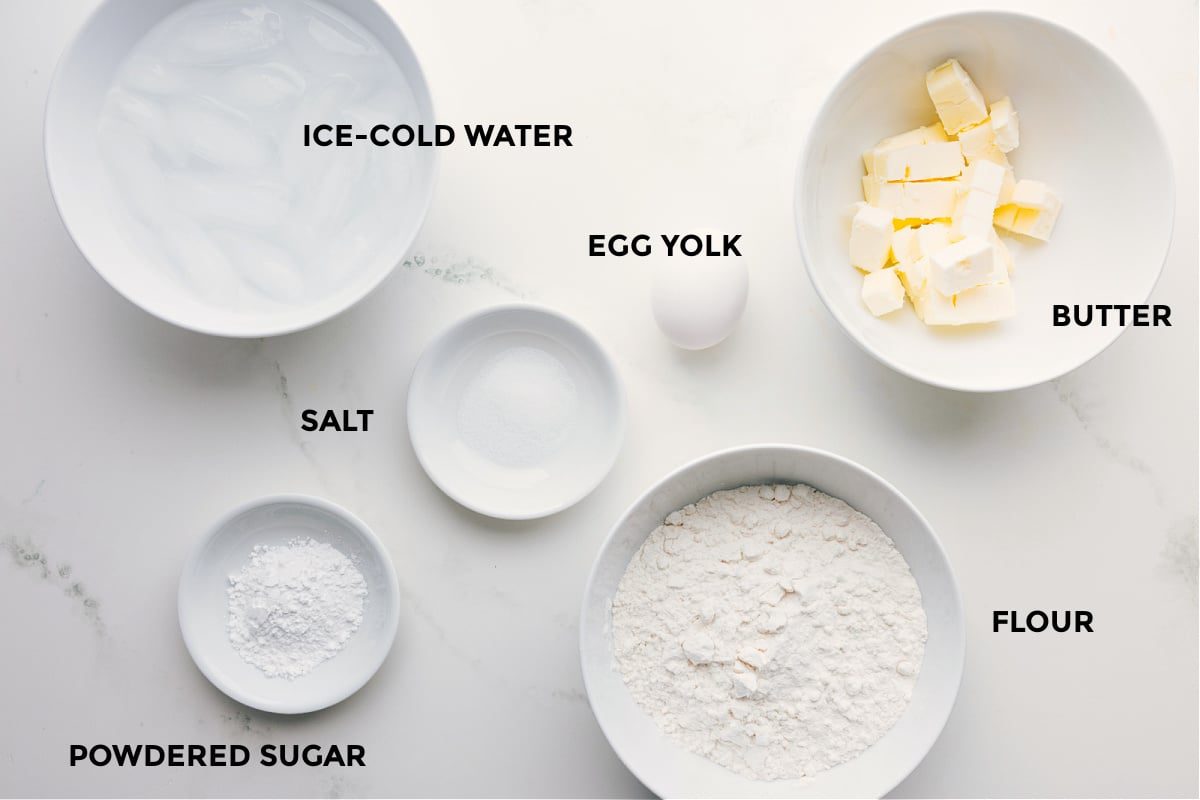 All the ingredients prepped and ready: flour, butter, egg, salt, powdered sugar, and ice cold water for straightforward assembly.