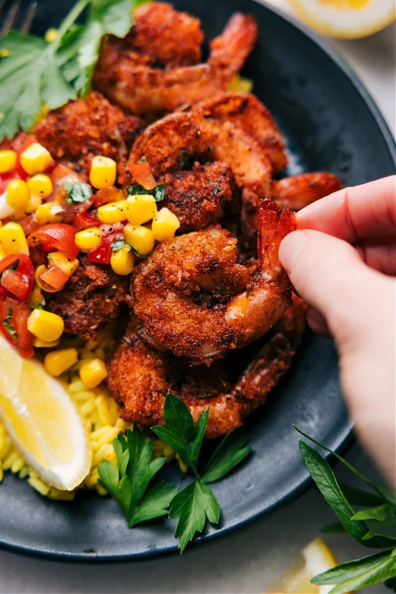 Blackened Shrimp Recipe with one of the shrimp being picked up.