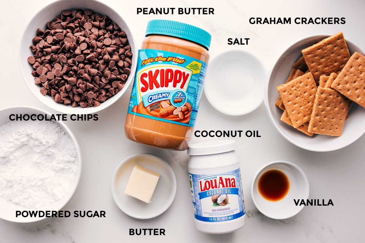 All the ingredients in this recipe prepped out for straightforward assembly including the chocolate chips, powdered sugar, butter, peanut butter, coconut oil, salt, vanilla, and graham crackers.