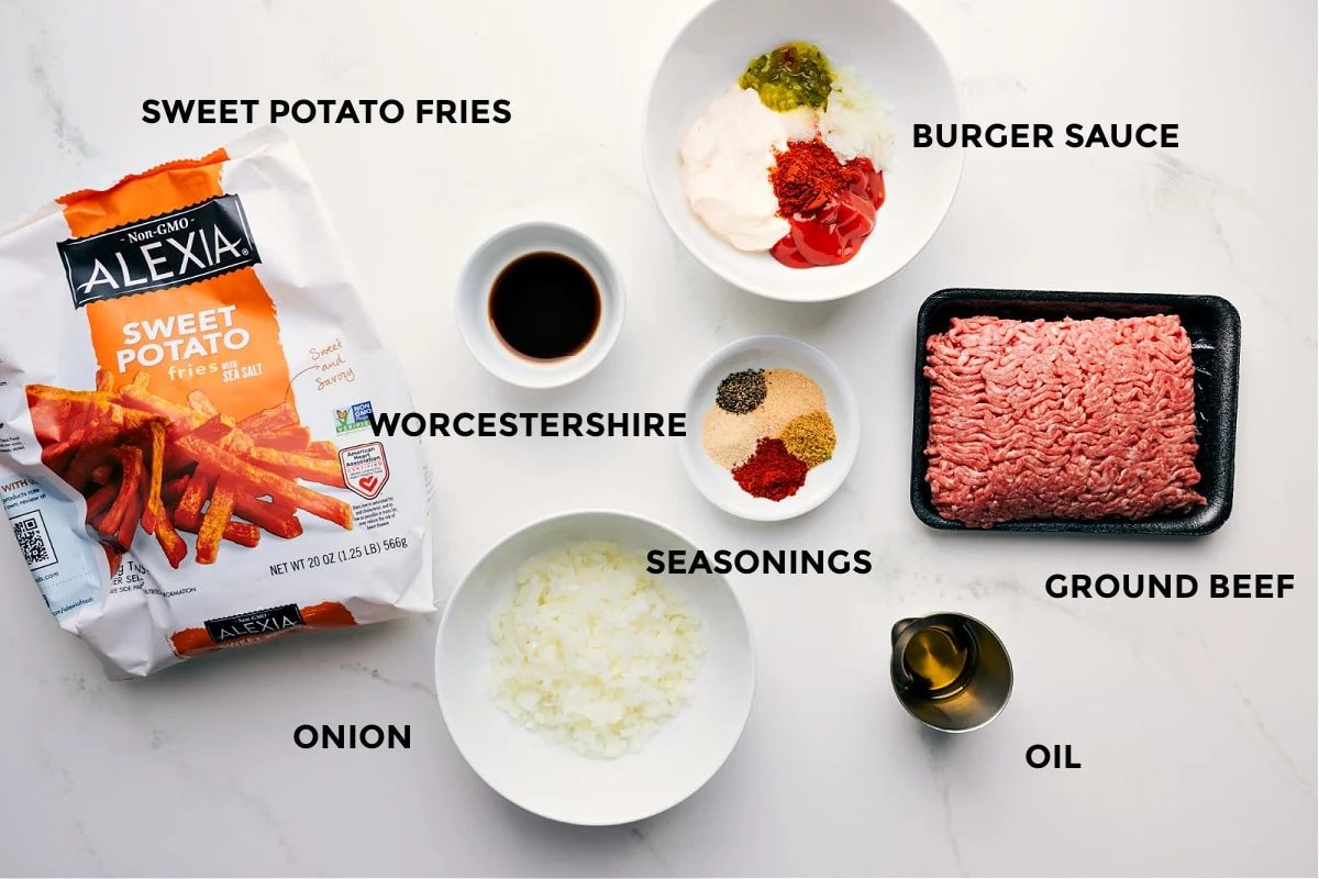 All the ingredients prepped for straightforward assembly—sweet potato fries, burger sauce, Worcestershire, spices, ground beef, oil, and onion.