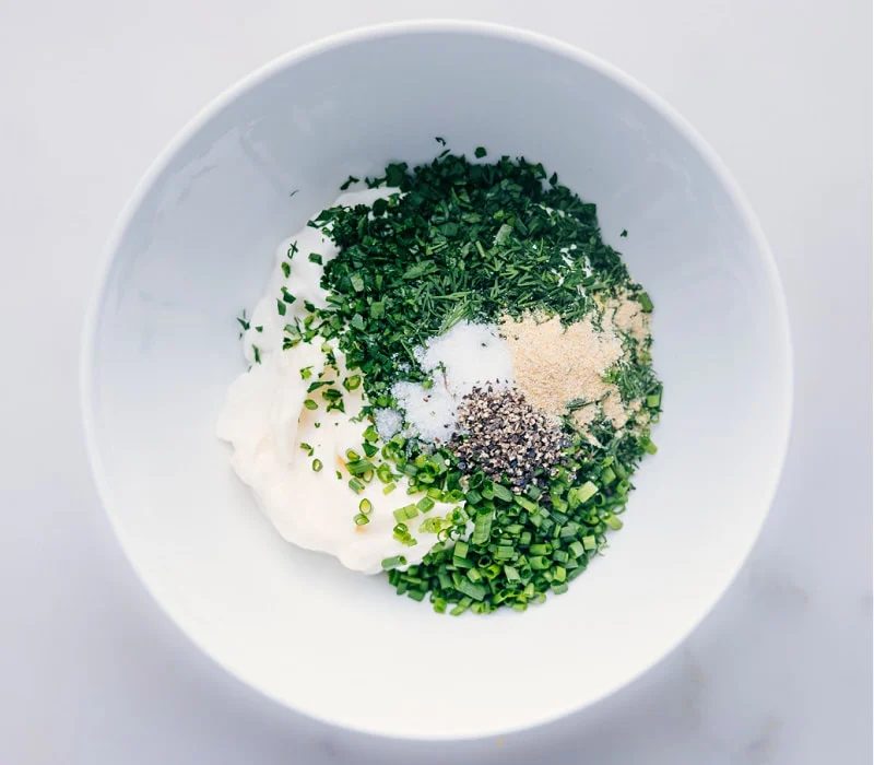 All the ingredients in this dressing added into a bowl to be mixed together.