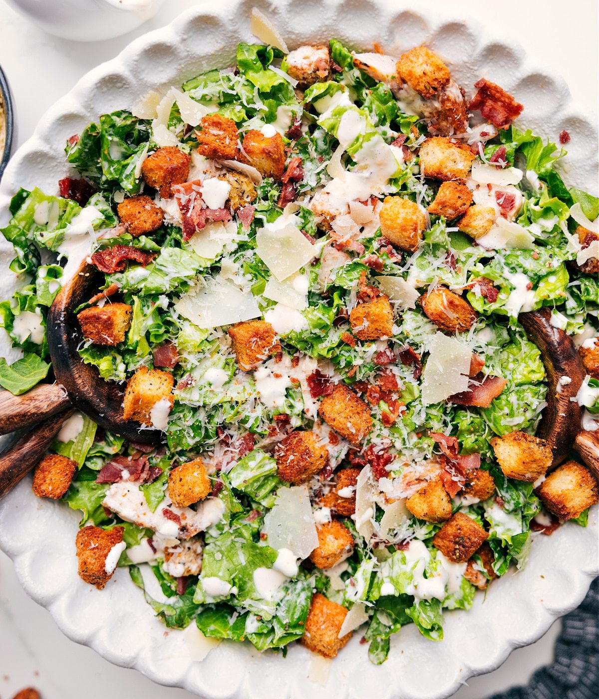A salad tossed with the dressing and topped with all the satisfying extras for a satisfying dinner.
