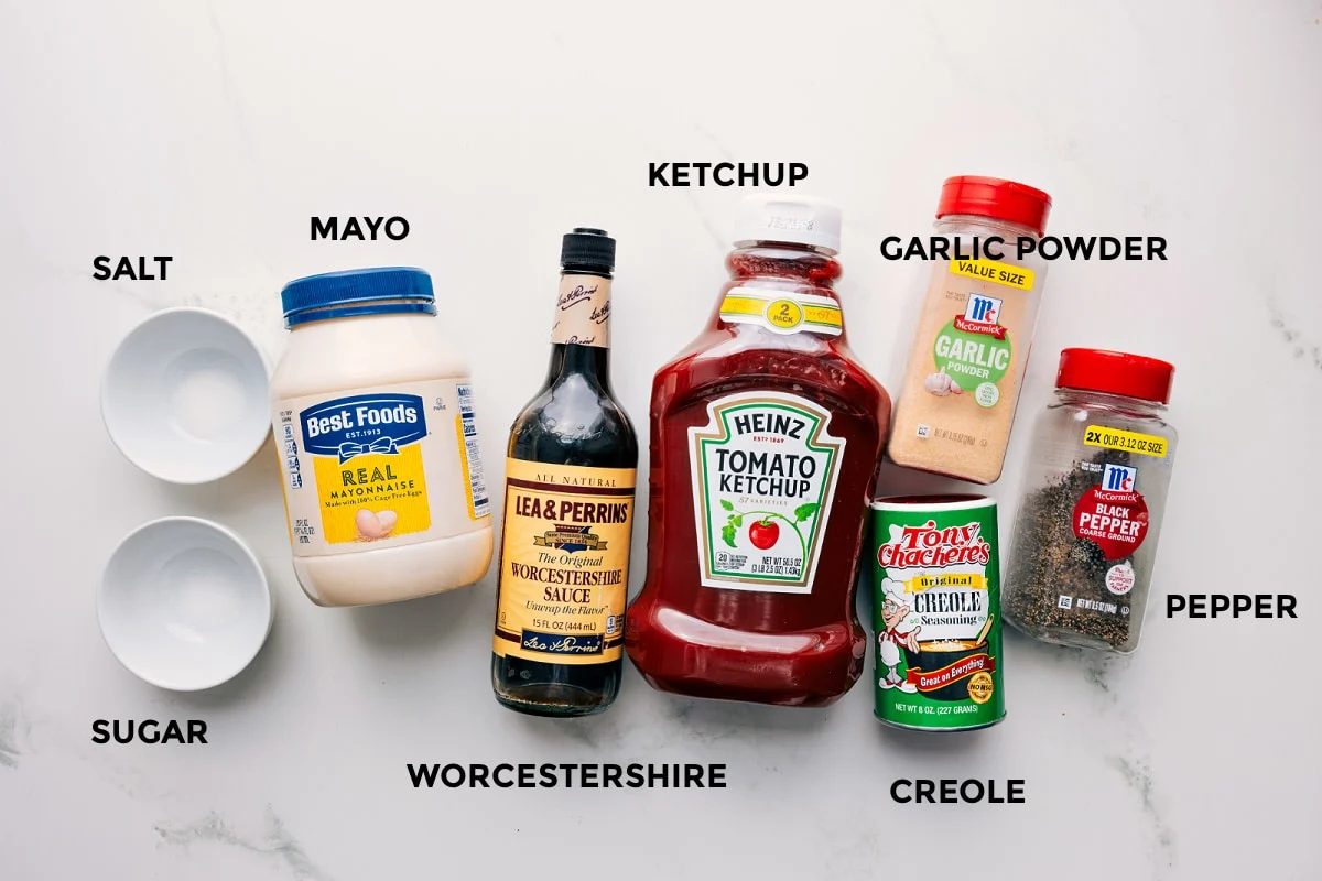 All the ingredients in this recipe prepped out for straightforward assembly including the salt, sugar, mayo, Worcestershire, ketchup, garlic powder, pepper, creole.