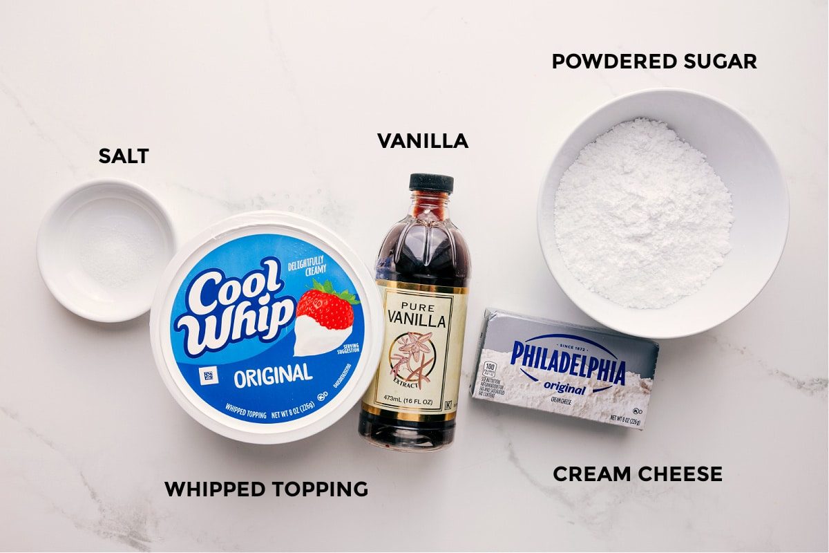 All the ingredients prepped out for straightforward assembly including the cream cheese, vanilla, whipped topping, salt, and powdered sugar.