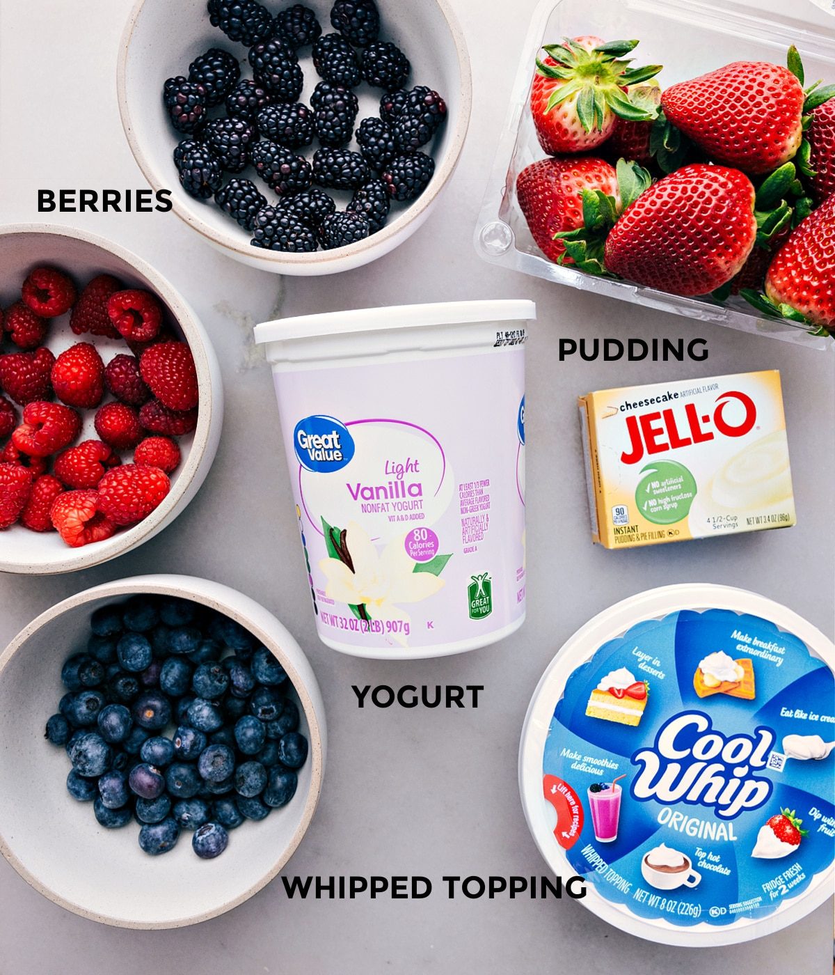 All the ingredients in this recipe prepped out for straightforward assembly including the berries, vanilla, jell-o, and cool whip.