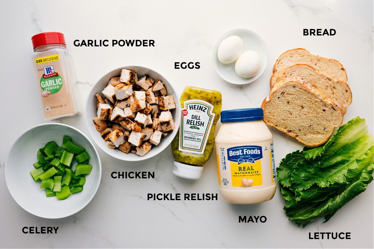 All ingredients for Chick-Fil-A Chicken Salad Recipe prepped and ready, including chicken, garlic powder, celery, relish, eggs, bread, and lettuce.