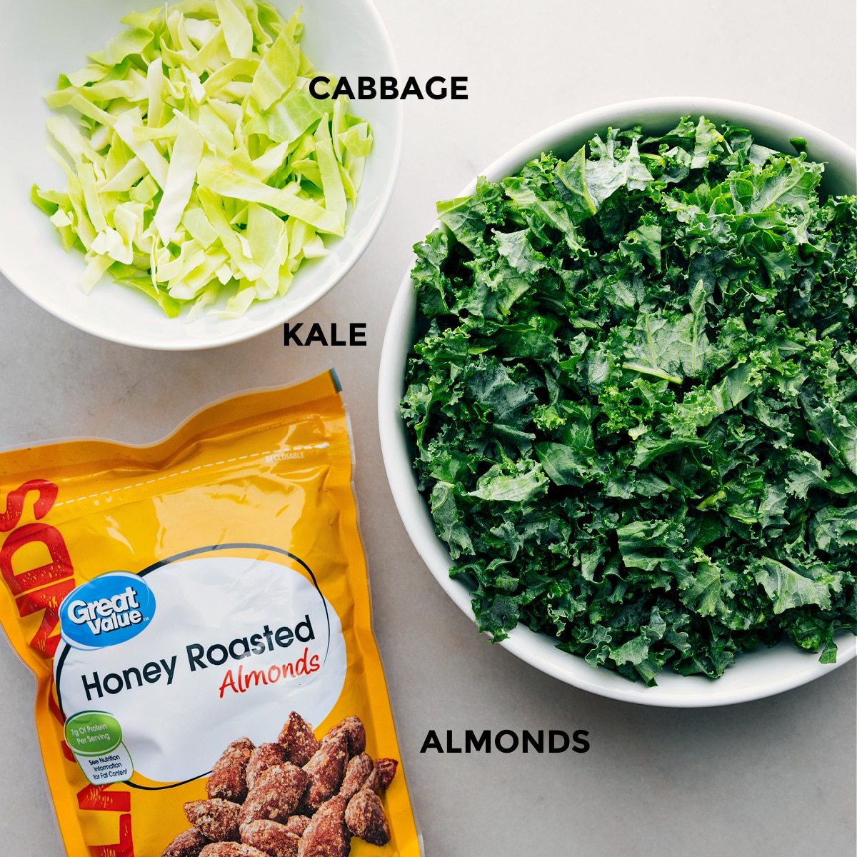 All the three ingredients including cabbage, kale, and almonds prepped out for straightforward assembly.