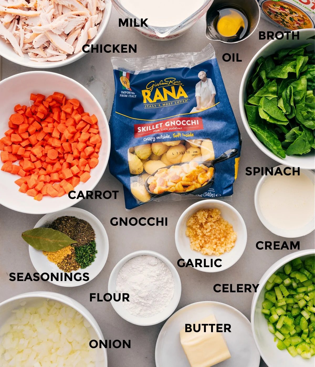 All the ingredients for this recipe are prepped for straightforward assembly, including the veggies, gnocchi, broth, oil, milk, garlic, celery, cream, and seasonings.