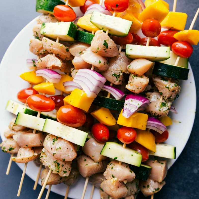 Uncooked chicken kabobs recipe, prepared and ready for grilling.