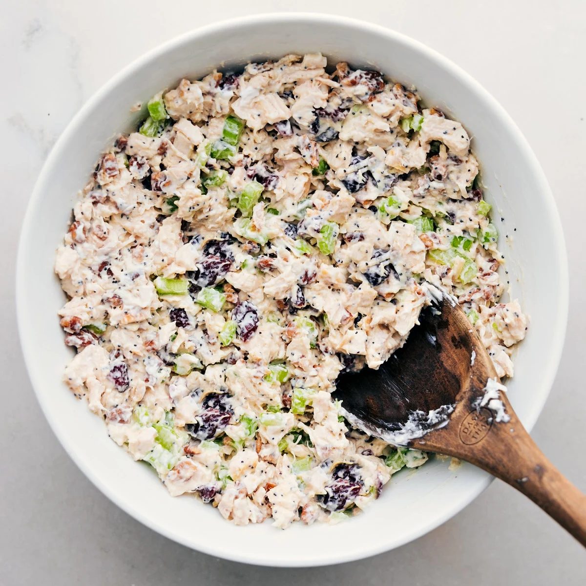 The chicken salad all combined in bowl ready to be served in some lettuce, on some bread, or however you enjoy it.