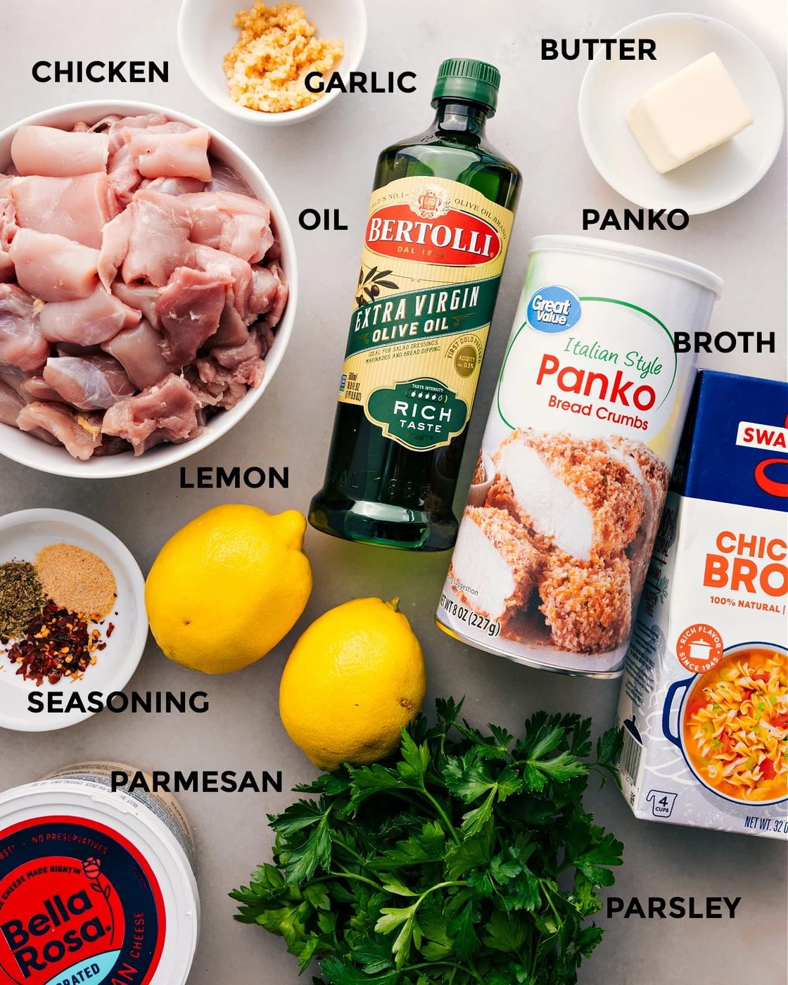 All the ingredients are prepped for straightforward assembly—meat, oil, panko, butter, garlic, broth, lemon, seasoning, parmesan, and parsley.