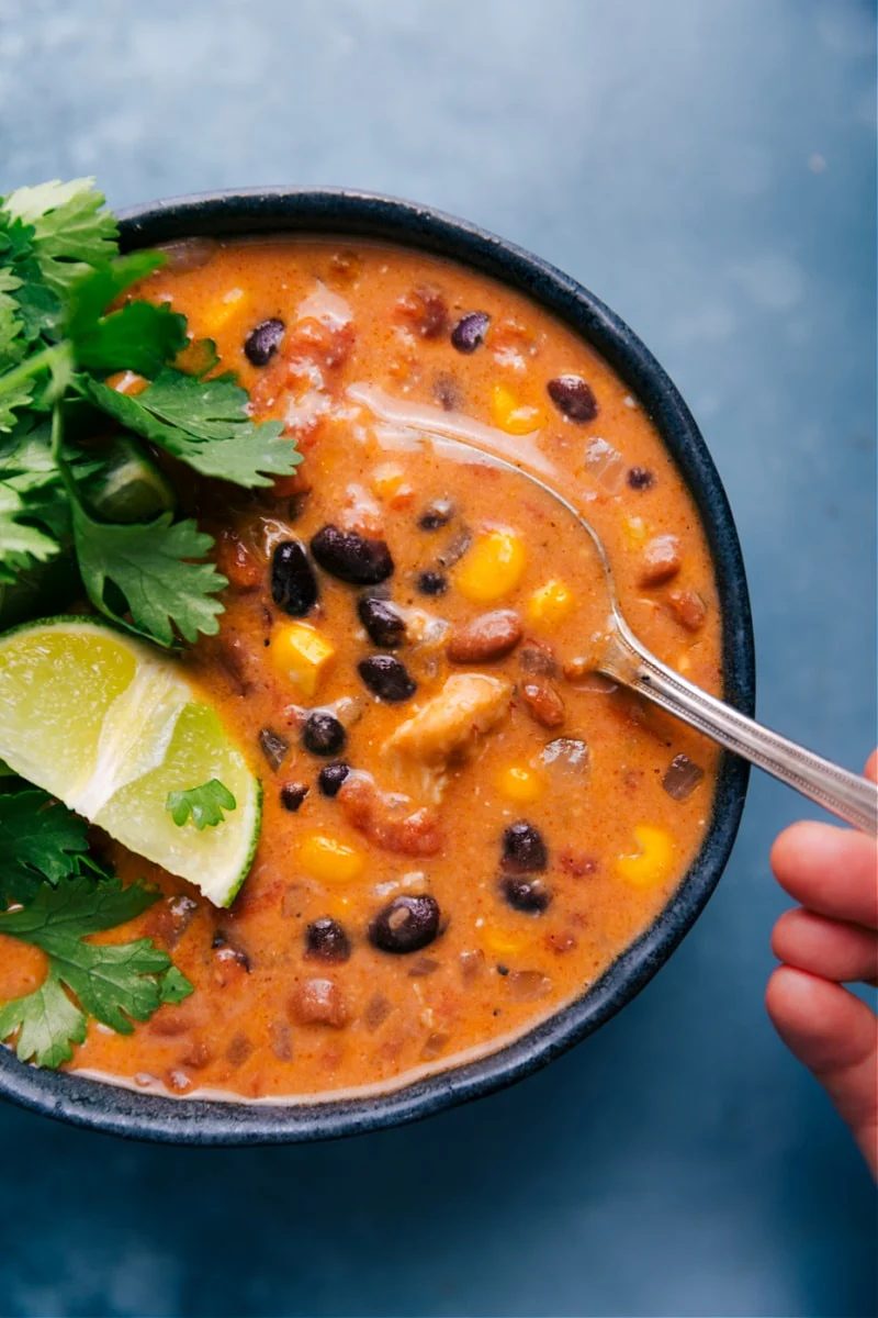 Chicken Tortilla Soup recipe in a bowl with a spoonful being taken out.