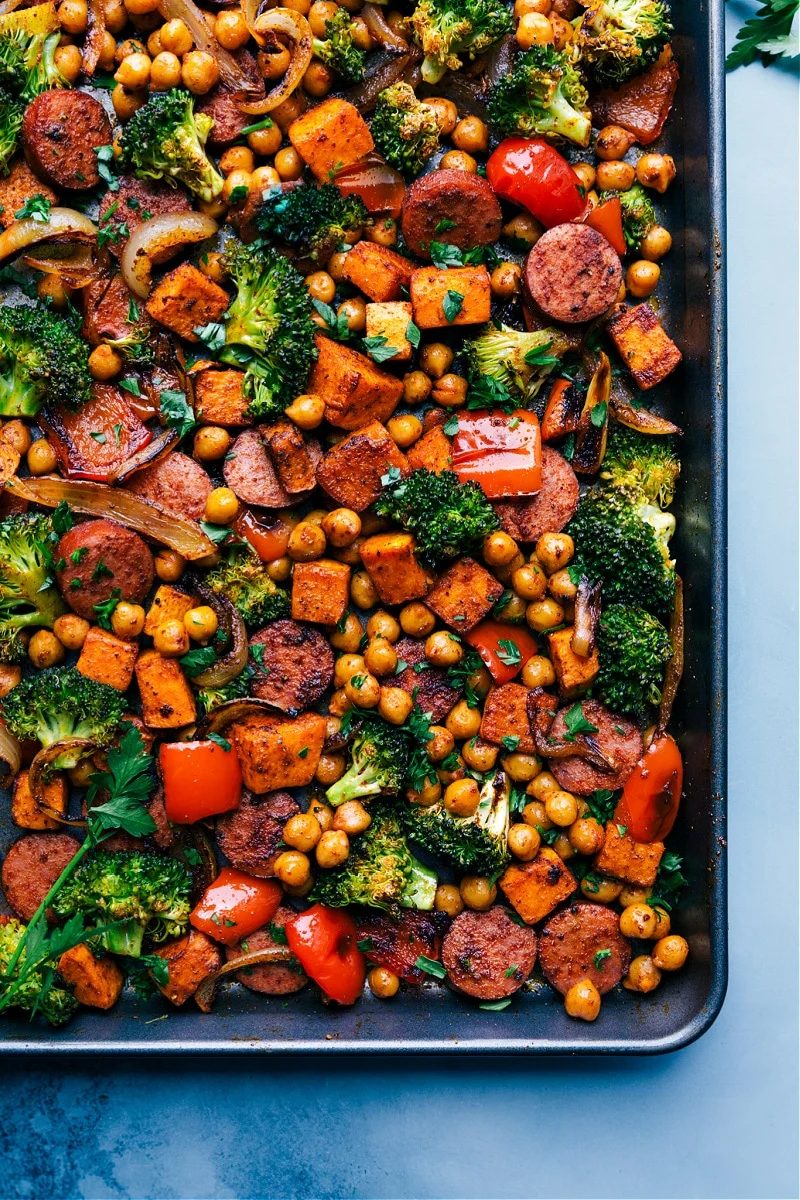 One pan sausage and chickpeas on a sheet pan, tossed in a Mexican-inspired seasoning blend.