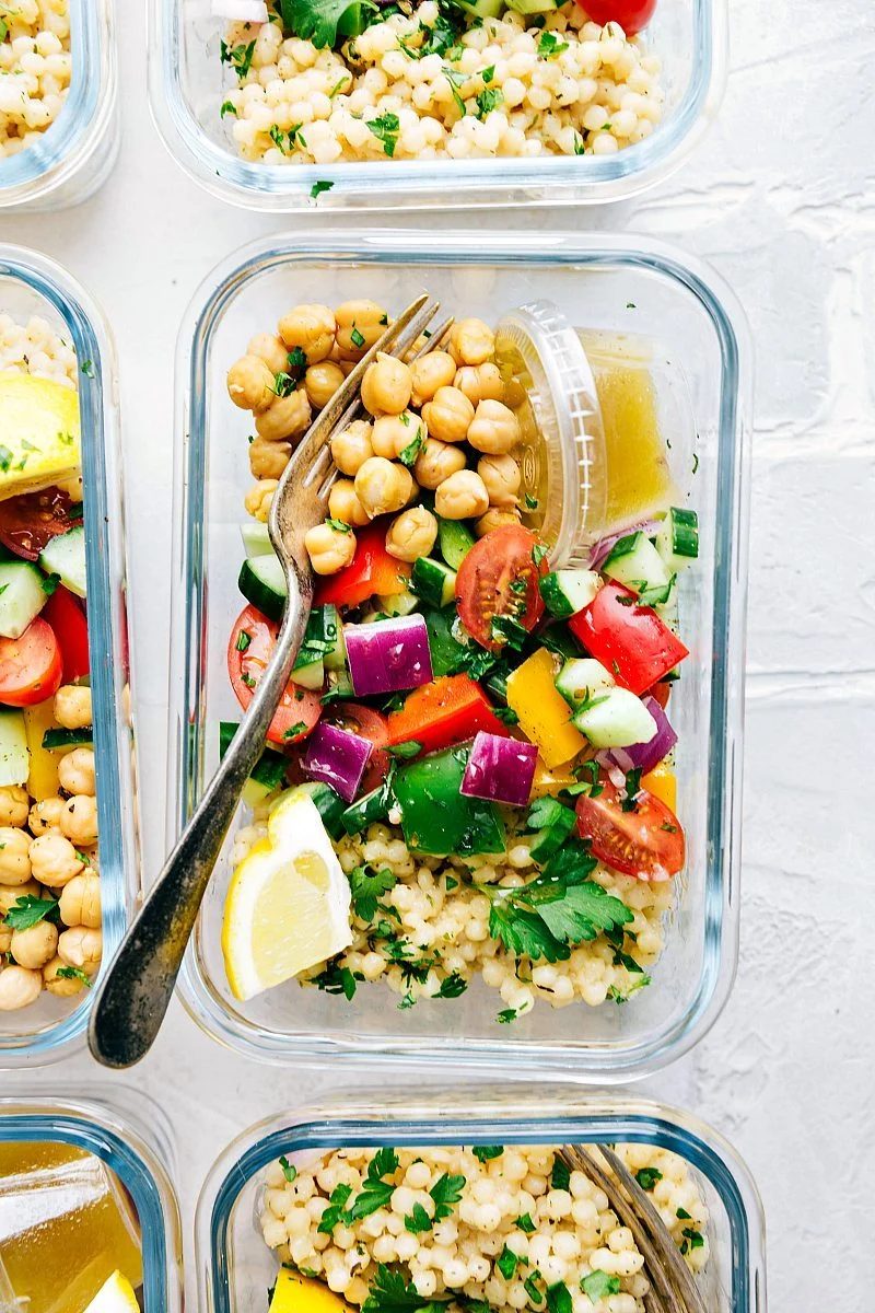 Greek couscous salad in meal prep containers.
