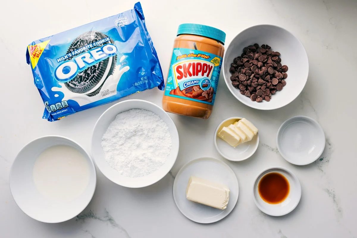 All the ingredients in this recipe prepped out for straightforward assembly including the Oreos, cream, butter, salt, creamy peanut butter, powdered sugar, and vanilla.