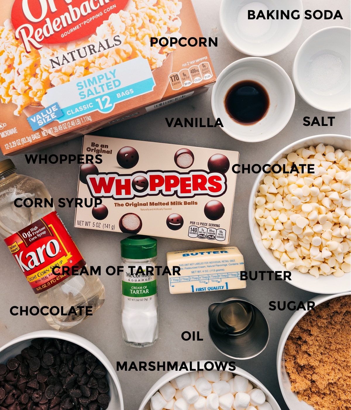 All the ingredients in this recipe are prepped for straightforward assembly: baking soda, salt, vanilla, popcorn, Whoppers, chocolate, cream of tartar, sugar, corn syrup, and butter.