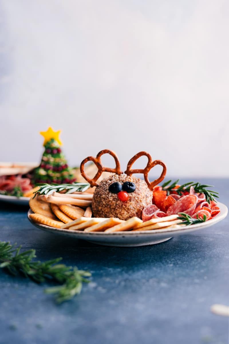 Reindeer Christmas cheese ball snack plate with crackers and meat on the side.