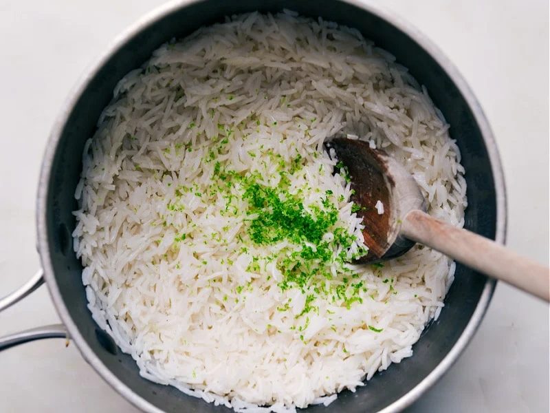 Adding lime zest and juice to the coconut rice.