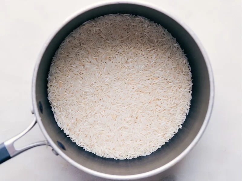 Adding rice to the pot.