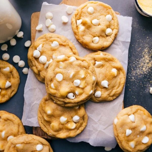 A batch of freshly baked cornmeal cookies, each one topped with white chocolate chips, satisfying and flavor-packed.