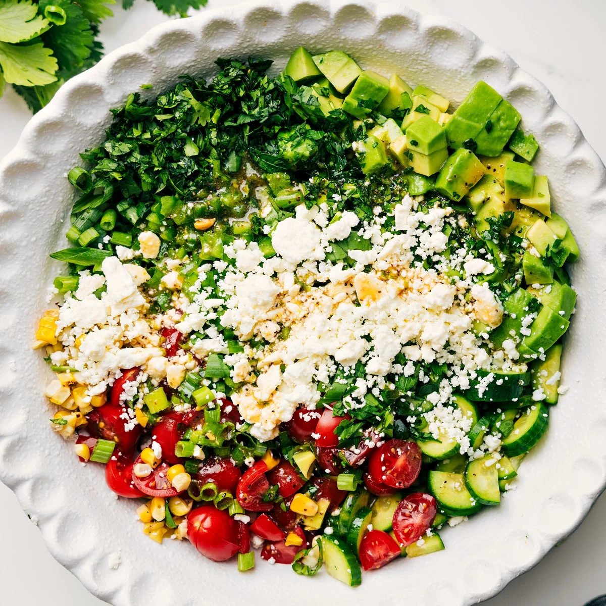 All the ingredients in this corn salad recipe added into a bowl to be tossed together.