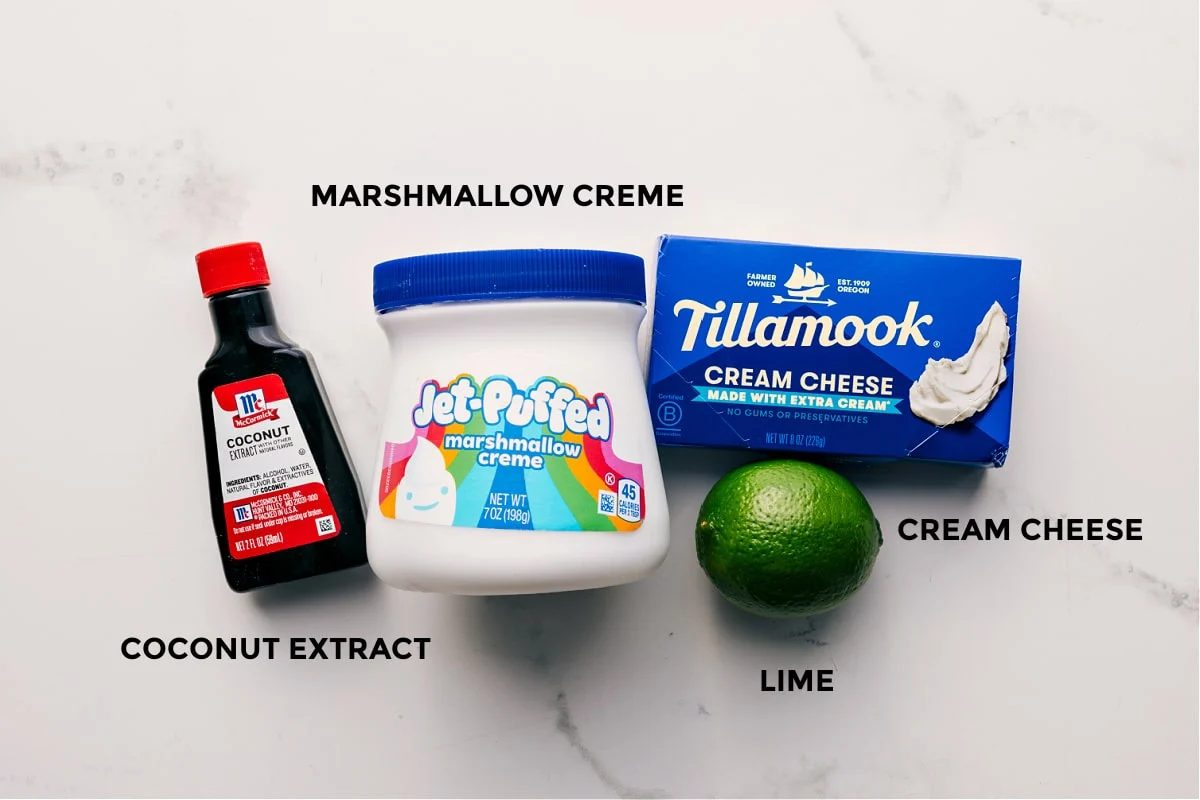 All the ingredients in this recipe prepped out for straightforward assembly including the coconut extract, marshmallow creme, cream cheese, and lime.