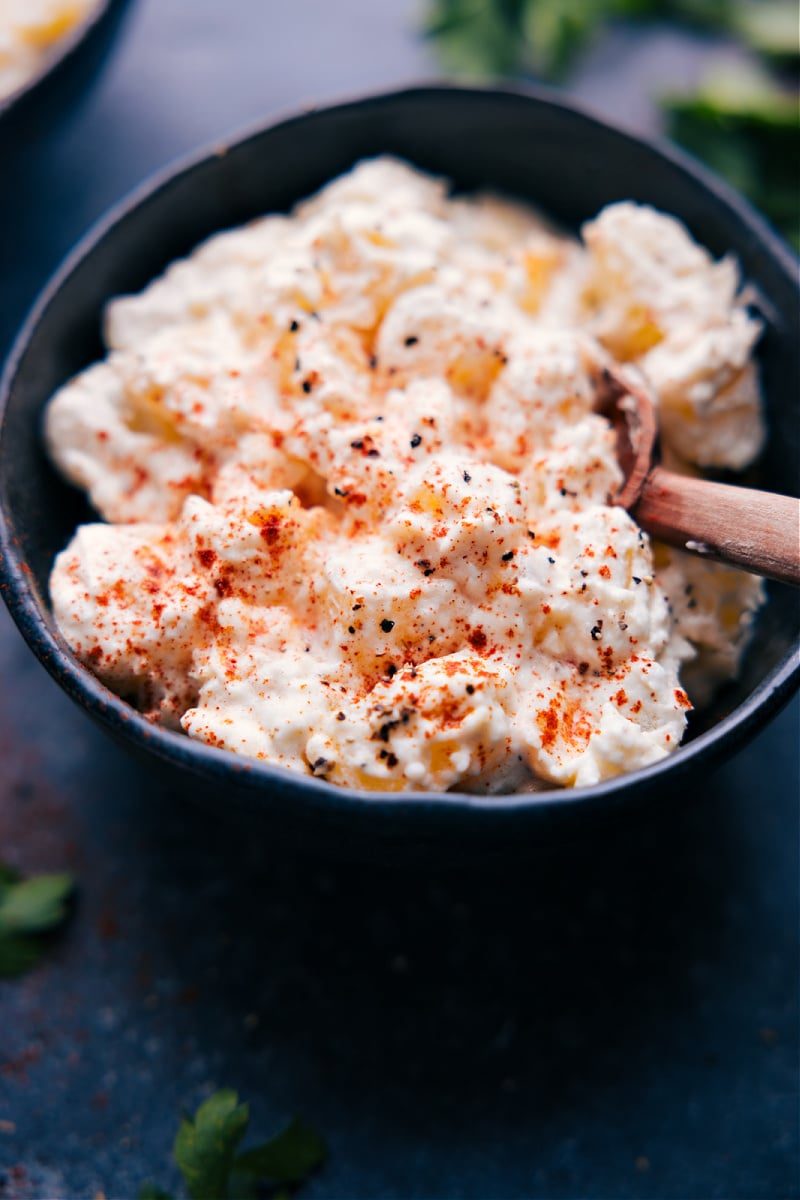 Creamed Potatoes Recipe in a bowl with seasonings on top.