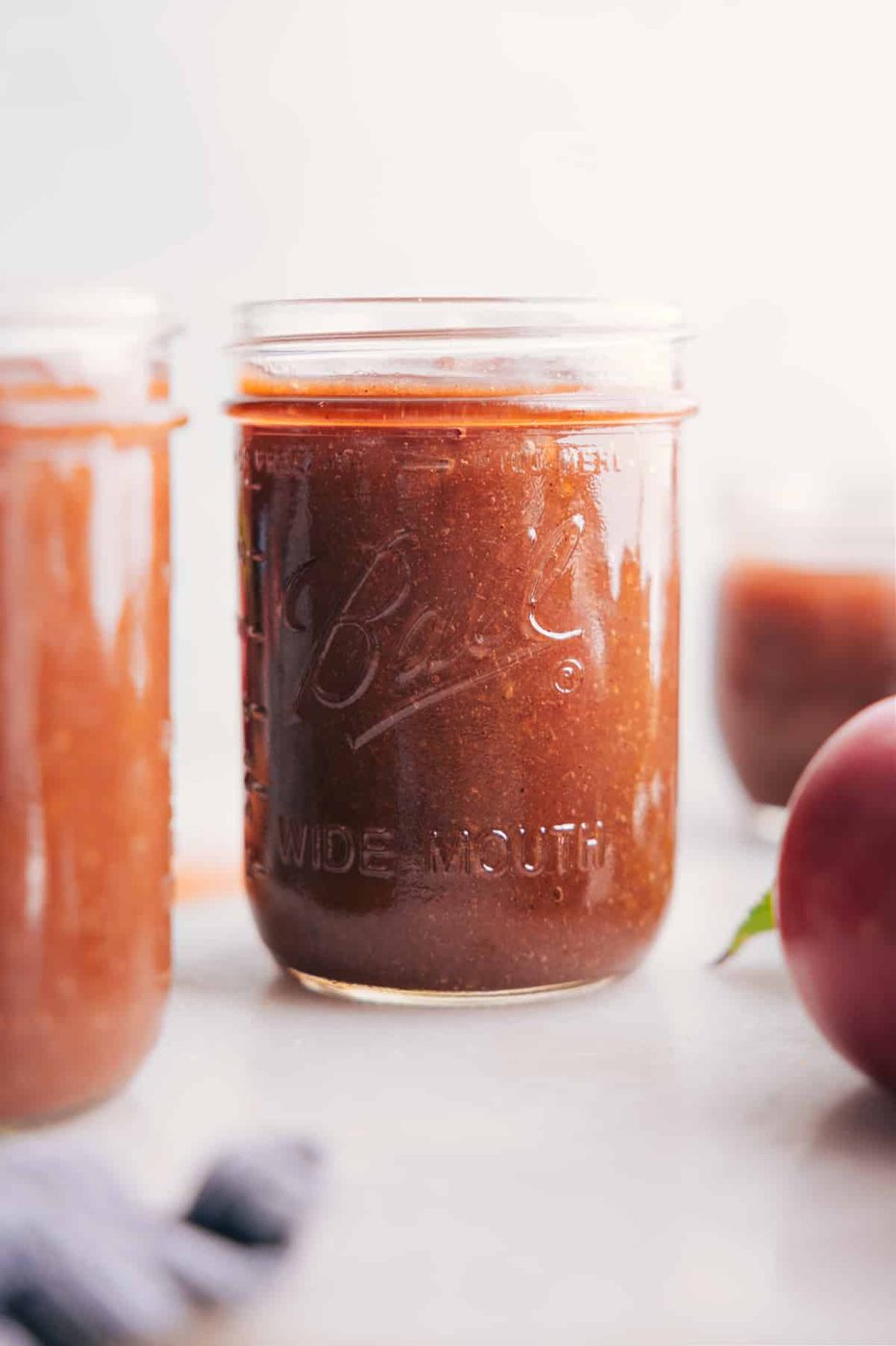 Glass jar filled with rich, smooth slow cooker Apple Butter.