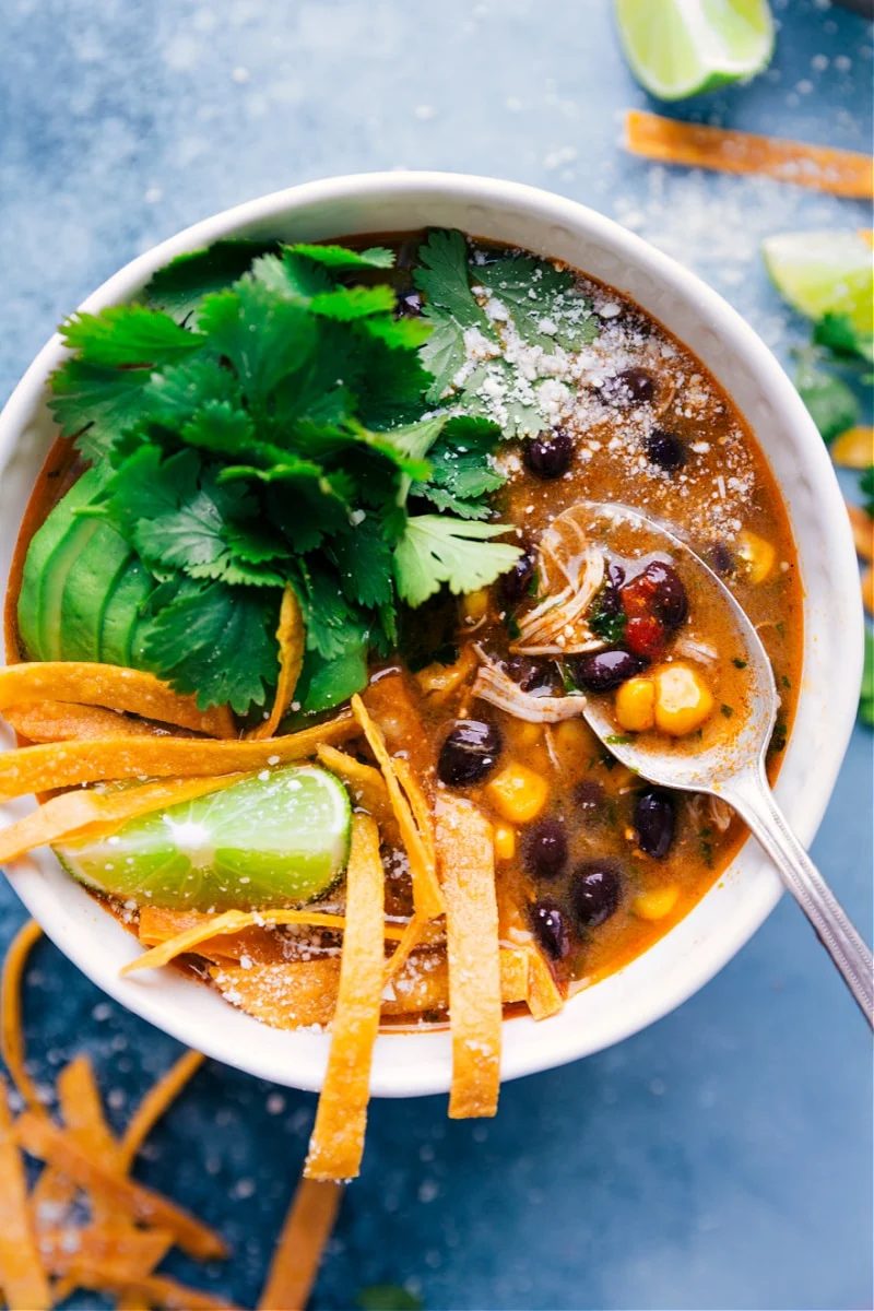 slow cooker chicken recipes featuring Salsa Verde Chicken Soup with shredded chicken, beans, corn, and salsa verde.