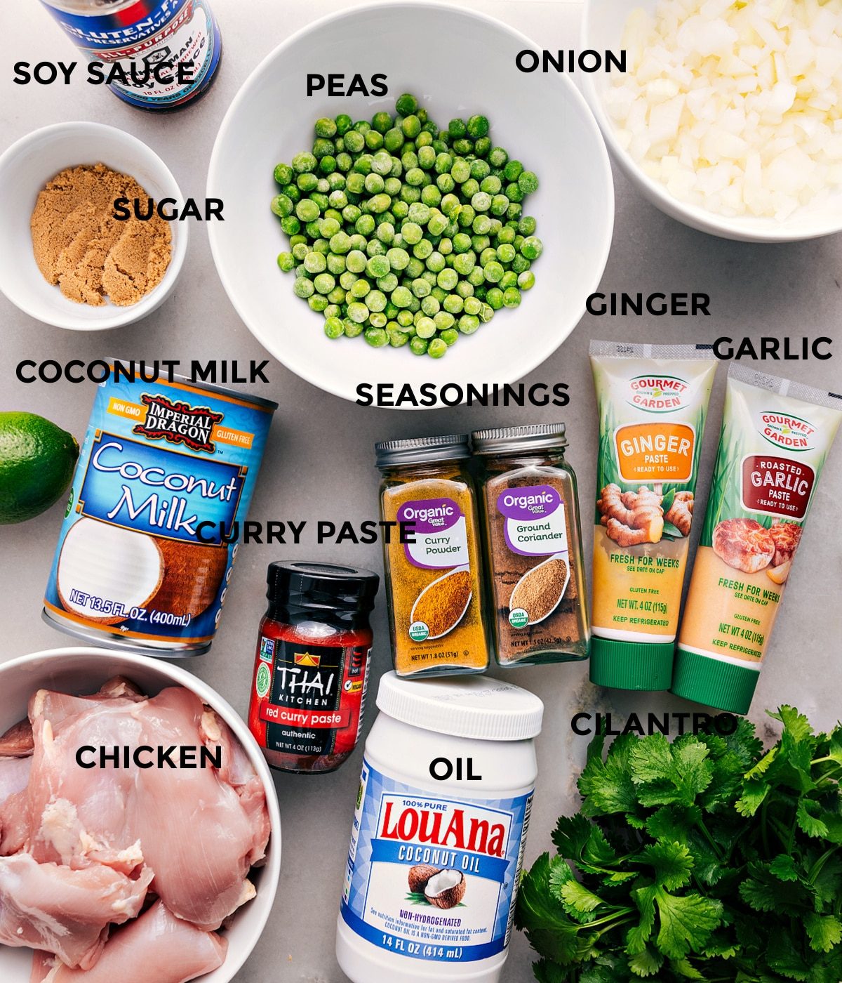 All the ingredients are prepped for straightforward assembly—peas, onion, garlic, ginger, seasonings, soy sauce, sugar, coconut milk, red curry paste, meat, oil, and cilantro.