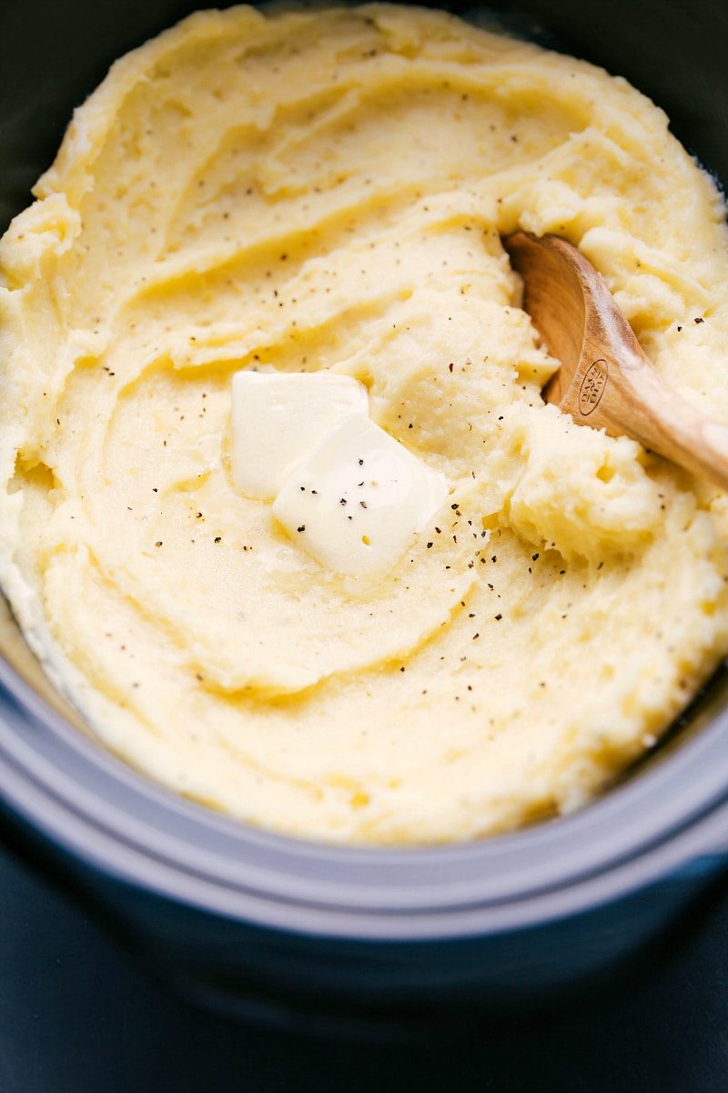 The finished slow cooker mashed potato recipe topped with a dollop of butter, ready to be enjoyed.
